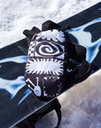 The KO Mitt x Glitterstudio Black mitten resting on a snowboard in the snow