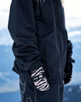 snowboard mittens with zebra pattern in a snowy mountain backdrop.