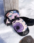 The Team Transform x Eivy Big Flower snowboard mittens on snow with vibrant floral design, Primaloft insulation, and Hipora waterproof inserts.