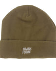 Heavyweight tan fleece snowboard beanie with extra perch, rubber logo, and gender-neutral sizing, suitable for snowboarding.